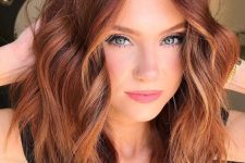 shoulder-length auburn hair with copper highlights and contouring, with messy waves and volume is a stylish and bold idea