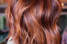 shoulder-length auburn hair with copper highlights, waves and volume, is a stunning solution to rock