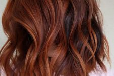 shoulder-length auburn hair with orange highlights and waves is a veyr eye-catchy and cool idea to rock