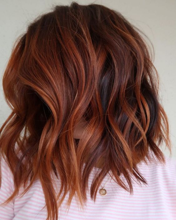 Shoulder length auburn hair with orange highlights and waves is a veyr eye catchy and cool idea to rock