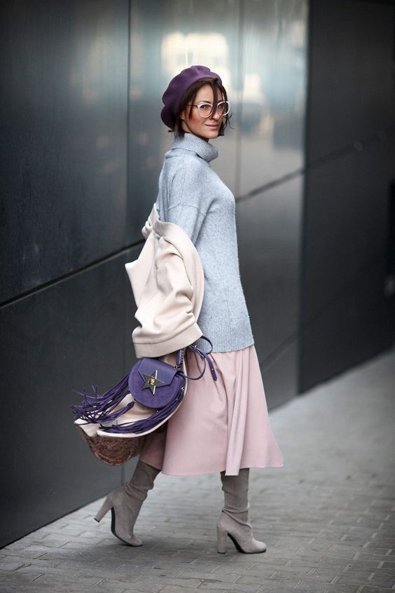 a blush midi A-line skirt, a powder blue sweater, grey boots, a purple beret and a bag, a creamy coat