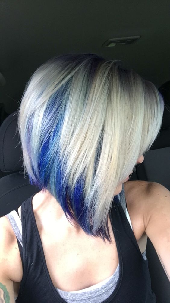 a blonde angled bob with electric blue peekaboo highlights for a fashionable touch