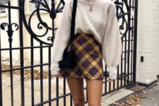 04 a neutral oversized cashmere sweater, a bright plaid mini skirt, white sneakers and a black bag