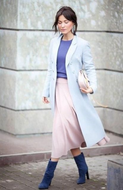 a blush midi A line skirt, a purple top, a light blue coat, electric blue booties