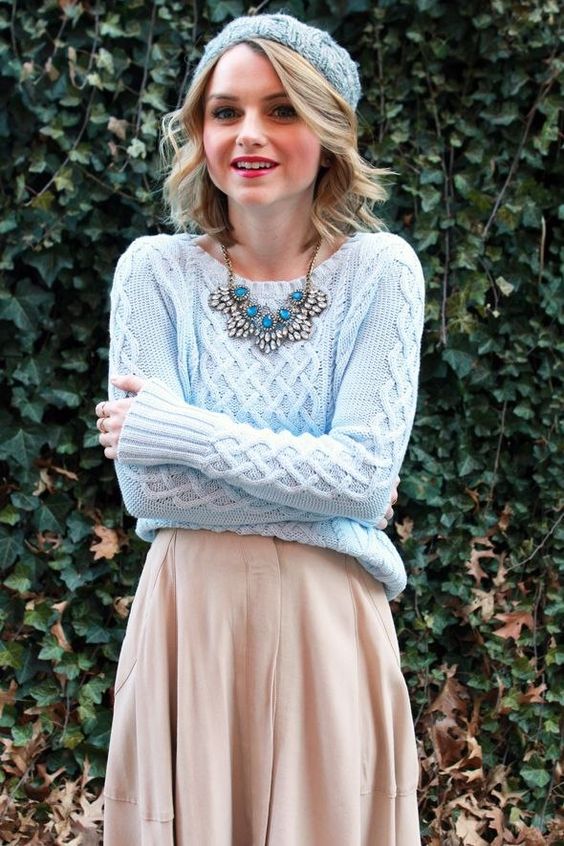 a neutral skirt, a powder blue sweater and a matching beanie plus a statement necklace for a vintage feel