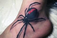 Black and red spider tattoo on the foot
