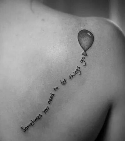 Black balloon with phrase tattoo on the back