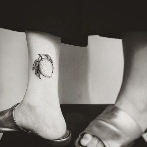 Black-contour tattoo on the ankle