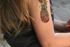 Colored pineapple tattoo on the arm