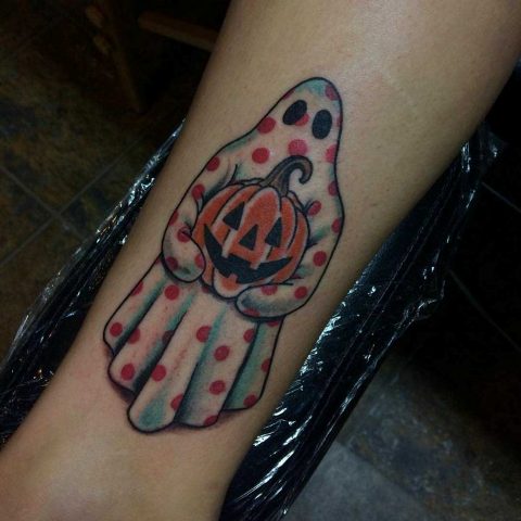 Colorful tattoo with a ghost and a pumpkin
