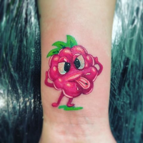 Funny raspberry tattoo on the wrist