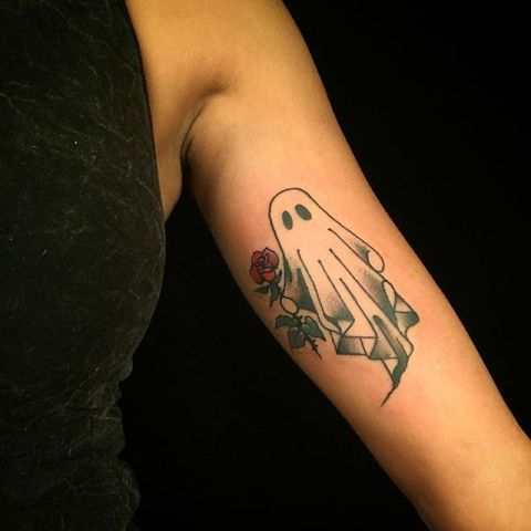 Ghost and red rose tattoo on the arm