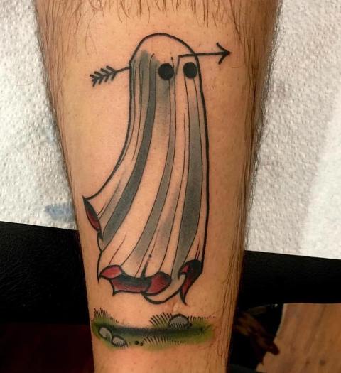 Ghost with arrow tattoo on the leg
