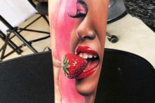 Girl and strawberry tattoo on the hand