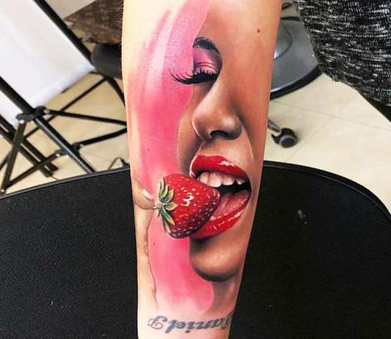 Girl and strawberry tattoo on the hand