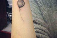 Gray tattoo on the forearm