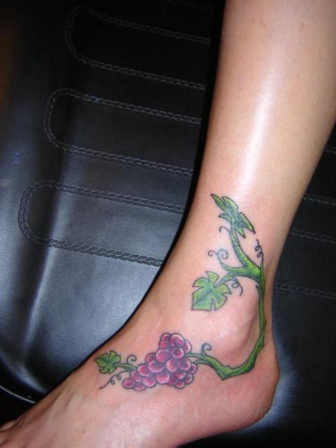 Green and purple tattoo on the ankle and foot