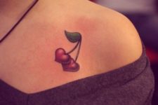 Heart shaped cherry tattoo on the shoulder