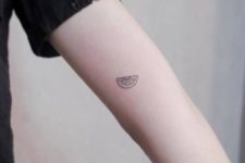 Lemon slice tattoo on the forearm