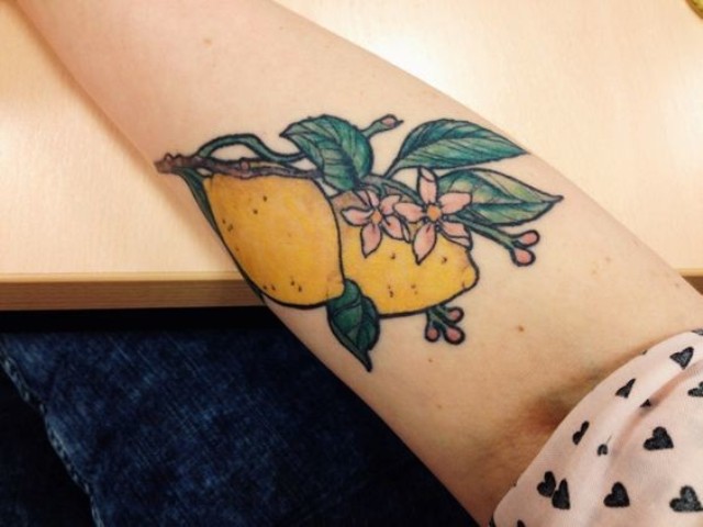 Lemons and flowers tattoo on the hand