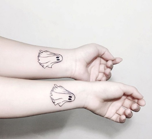 Matching Halloween tattoos on the wrists