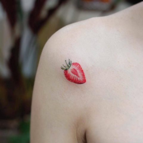 Minimalistic strawberry tattoo on the shoulder