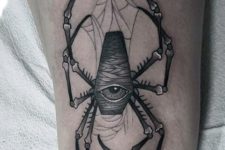 One eyed spider tattoo on the forearm