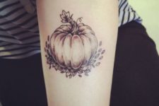 Pumpkin and leaves tattoo on the arm