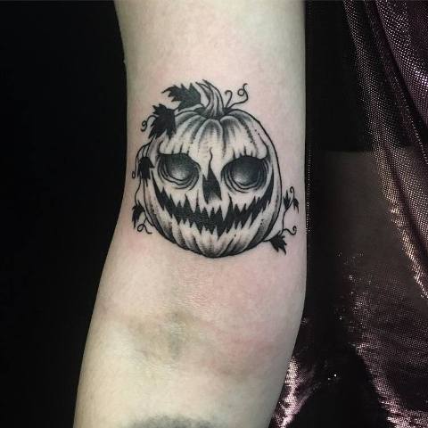 Scary pumpkin tattoo on the hand