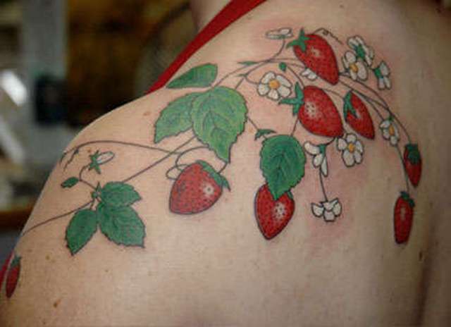 Several strawberries tattoo on the shoulder