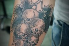 Skull grapes tattoo on the forearm