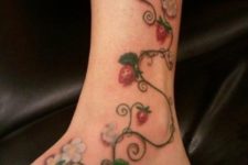 Strawberries, flowers and leaves tattoo on the leg