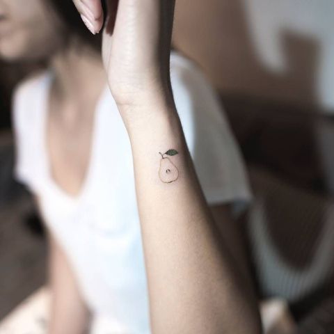 Tiny pear tattoo on the arm