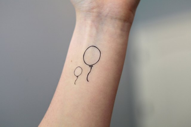 Two balloon tattoos on the wrist