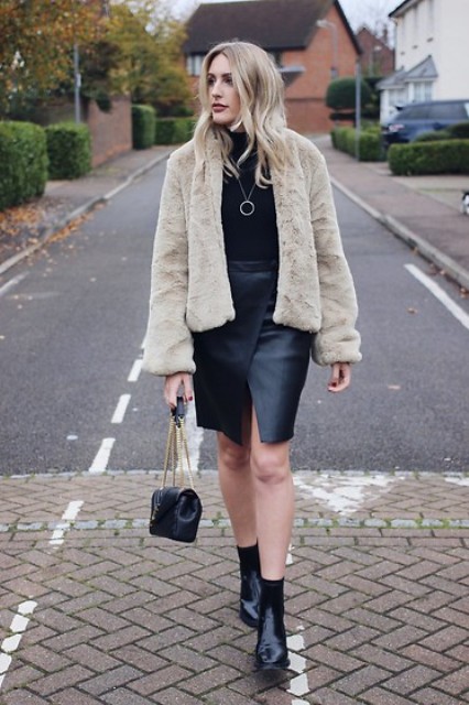 With black wrap skirt, black turtleneck, a mini bag and boots