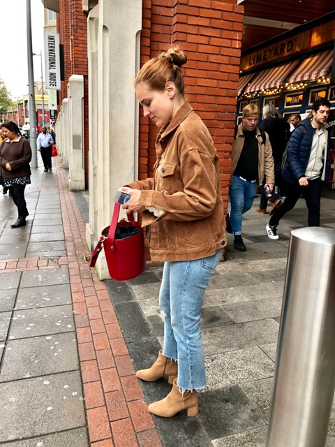 With crop jeans, suede ankle boots and red bag