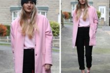 With light pink sweatshirt, pink coat, black trousers and platform shoes