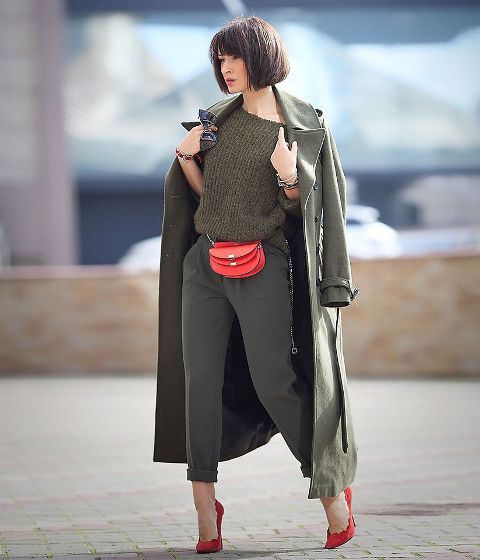 With one shoulder sweater, maxi coat, olive green pants and red pumps