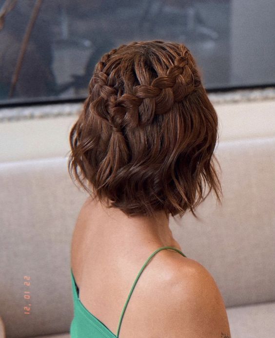 a half updo with a loose braided halo and waves down is a cool idea for a boho look