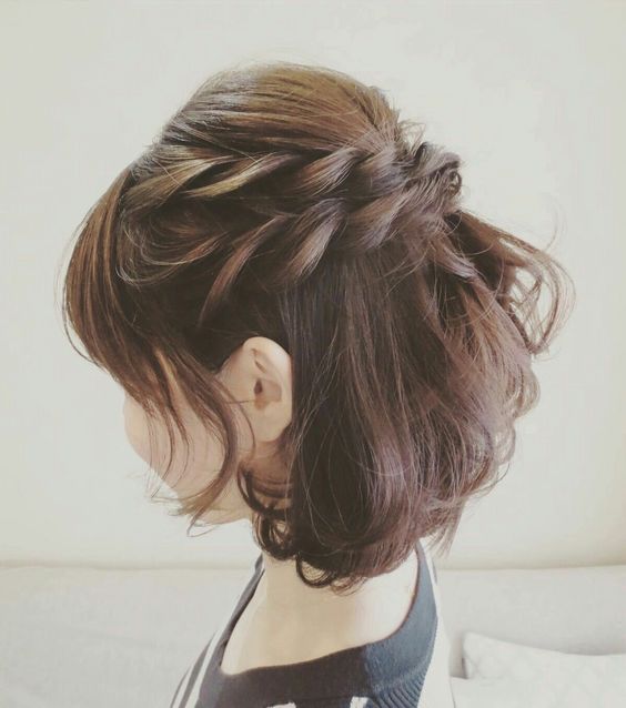 a pretty half updo with a double braid and a bump on top plus a lot of volumetric hair