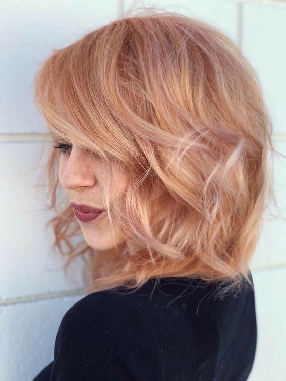 a shaggy and wavy peachy and strawberry blonde bob is a cool idea to look bolder this summer