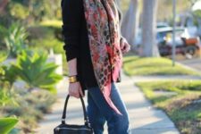 blue jeans, leopard booties a black sweater, a floral scarf and a black bag for a casual look