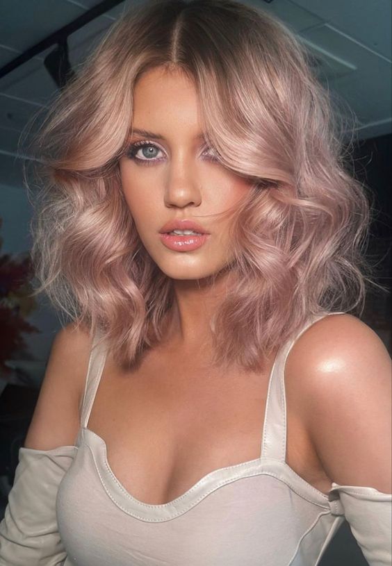 Gorgeous medium length strawberry blonde hair with waves and volume is a cool idea for any time