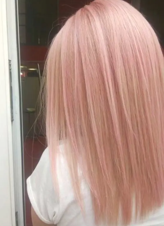 Long and straight peachy rose gold hair is a lovely idea to try this year if natural hair colors aren't interesting for you