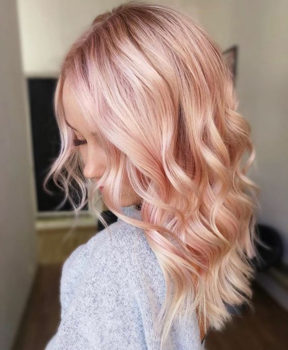 Medium length strawberry blonde hair with waves and volume looks very cute, chic and lovely