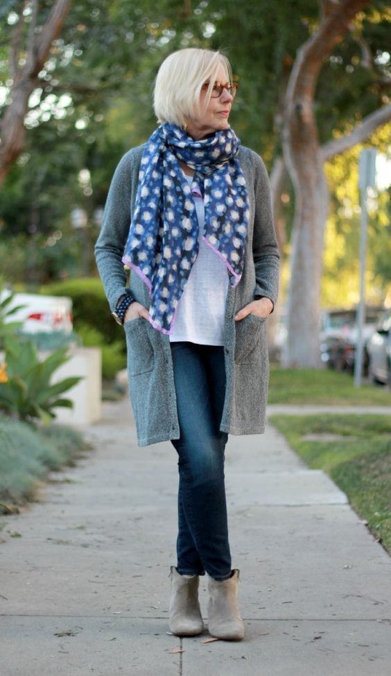 navy jeans, a white tee, a grey cardigan, grey booties, a floral scarf for a casual feel