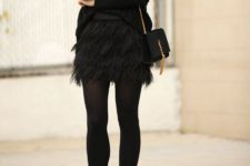02 a black oversized sweater, a black feather mini, black tights, black pumps, a black clutch