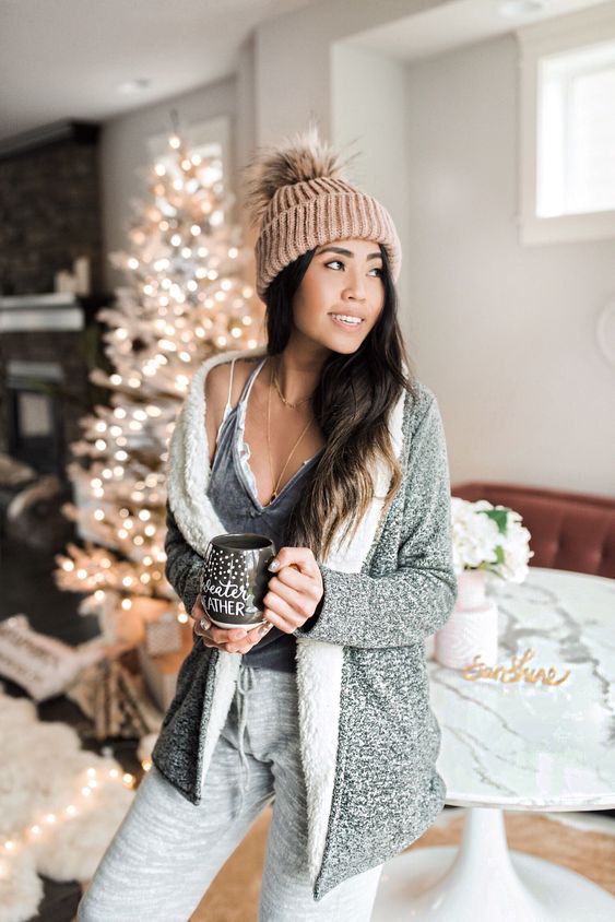 cozy home look with grey joggers, a grey top, a lace braletter, a faux fur cardigan and a blush beanie with a pompom
