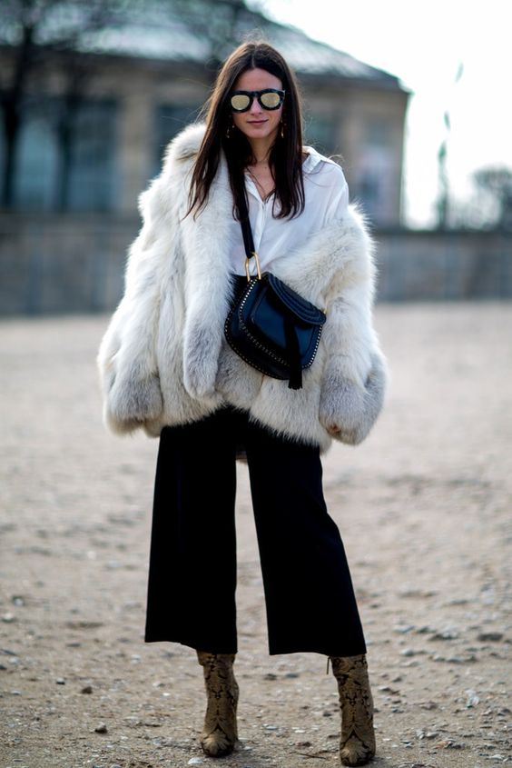 a white shirt, black culottes, a faux fur coat and snake print boots for a trendy feel