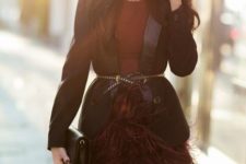13 a maroon mini dress with a feather skirt, a black blazer, a blakc embellished belt and a black clutch